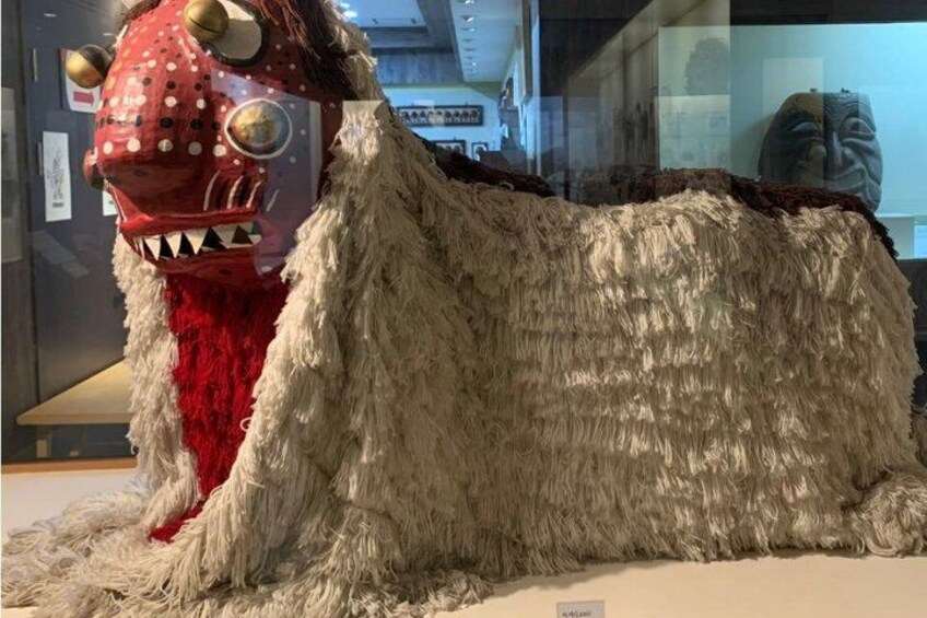 A large, furry creature with a red head and white body. 2
