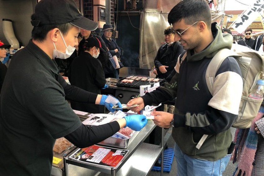 A street food vendor preparing food at a stall. 5