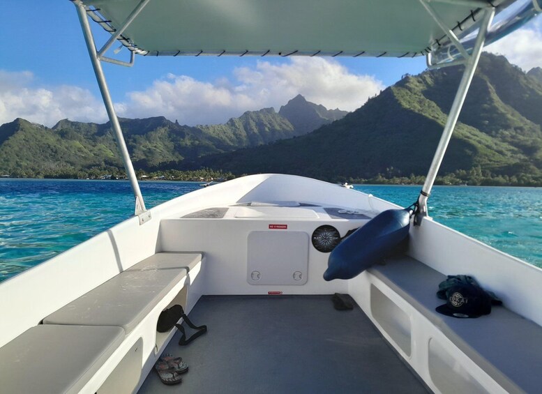 A boat with a view of a mountainous coastline and clear blue waters. 2