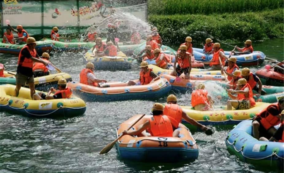 People in inflatable rafts on a river, wearing life jackets and paddles. 3