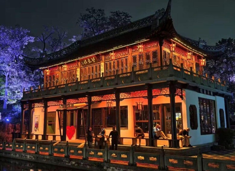 A traditional Chinese building with ornate architecture and illuminated details. 3