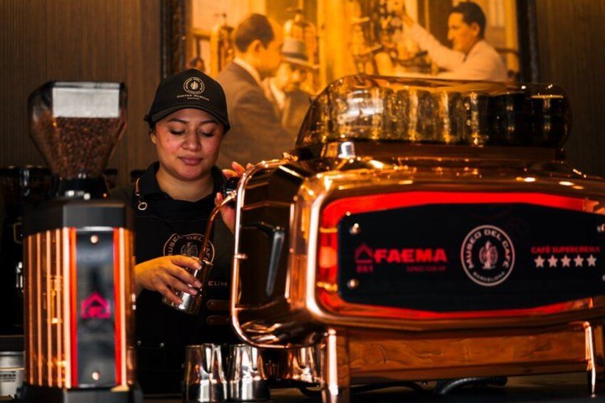 A person operating a coffee machine with a branded logo. 4
