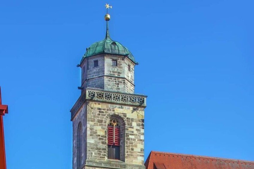 A tower with a green roof and a clock. 3