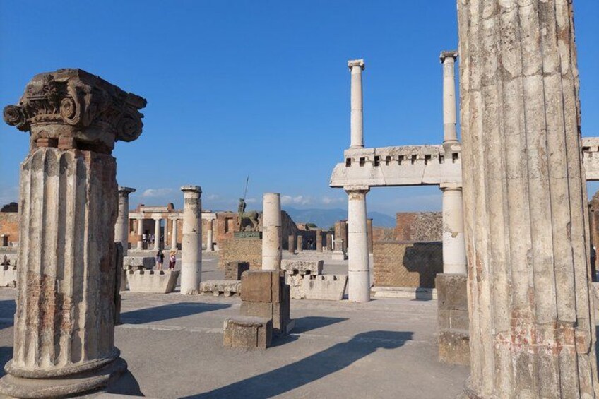 Ancient ruins with columns and stone structures. 4