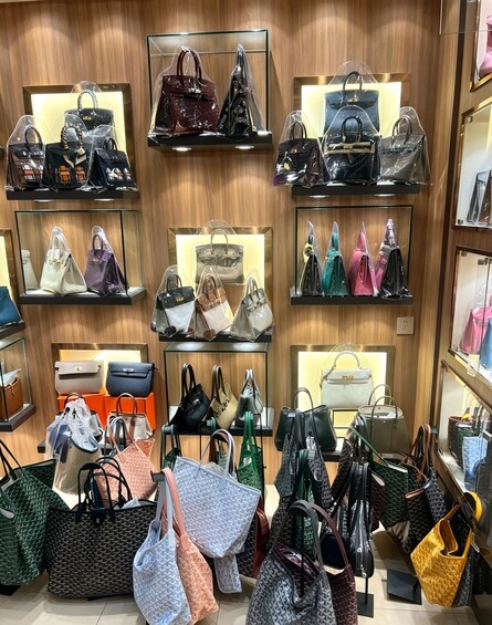 A variety of handbags displayed on shelves and racks in a store. 4