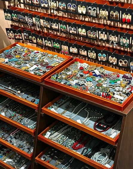 A jewelry store with multiple display cases filled with various types of jewelry including earrings, necklaces, and bracelets. 1