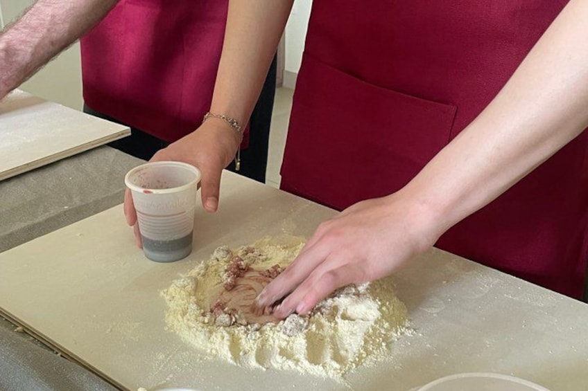 A person mixing ingredients in a bowl. 5