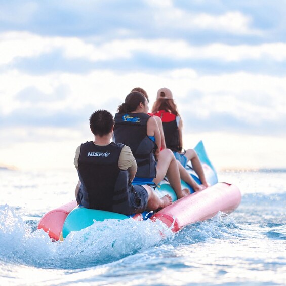 Three people on a watercraft with a clear sky in the background. 2