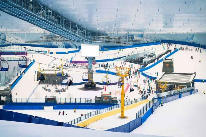 A ski resort with ski lifts, slopes, and a covered area. 2