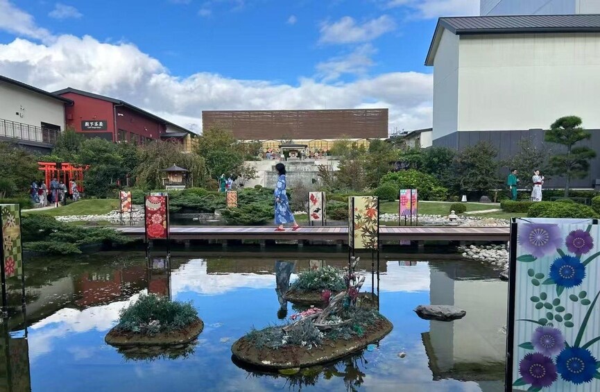 A serene garden with a pond, traditional Japanese architecture, and a red torii gate. 4