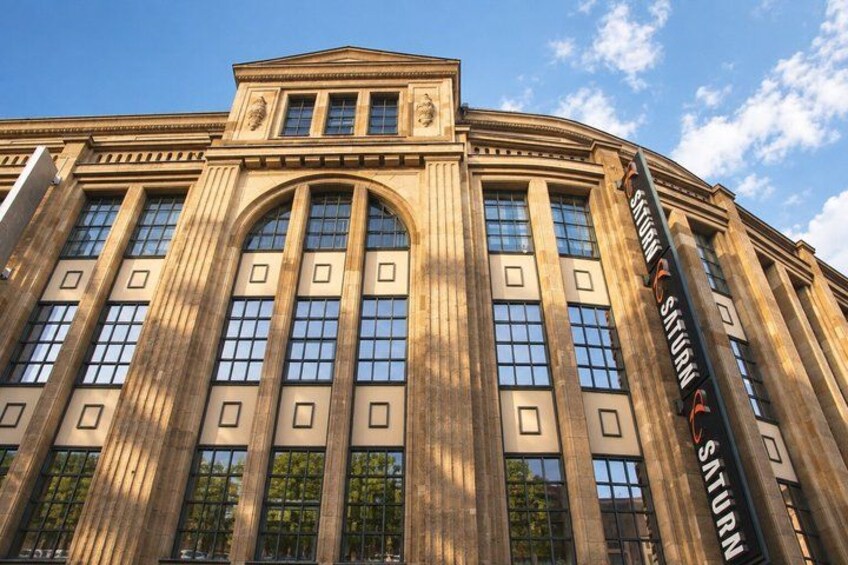 A large classical building with arched windows and columns. 4
