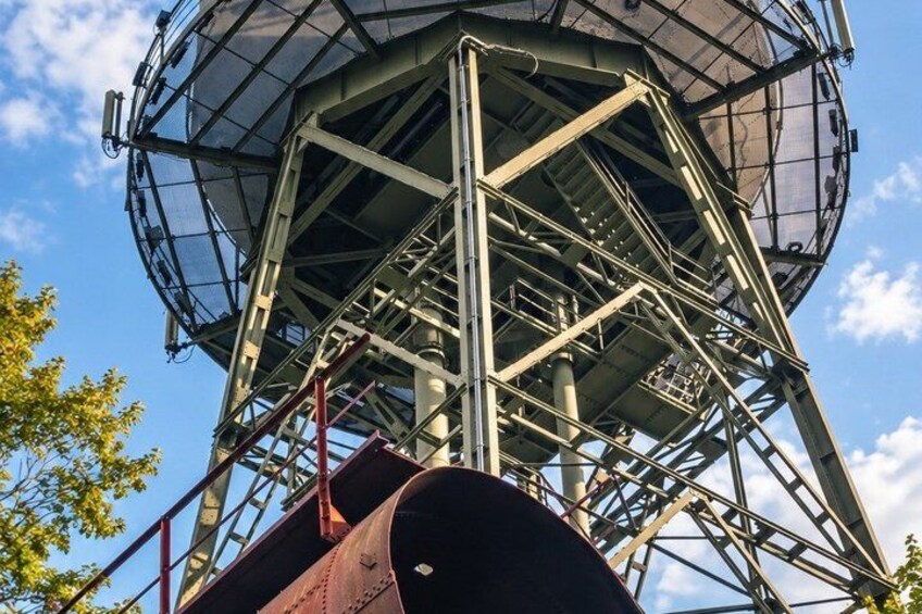 A large metallic structure with a circular observation platform, surrounded by a metal framework. 3