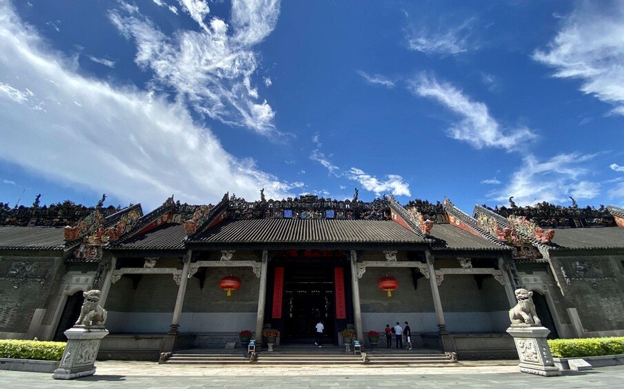 A traditional Chinese temple with ornate roofs and statues. 1
