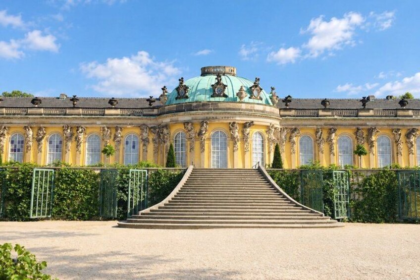 A grand palace with ornate architecture, a large staircase, and a dome. 4