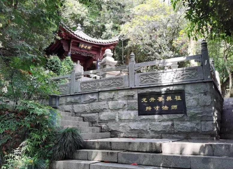 A stone staircase leading to a traditional Chinese pavilion surrounded by lush greenery. 2