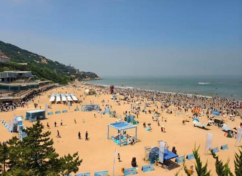 A crowded beach with tents and people. 2