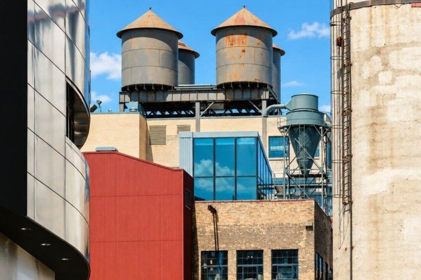 Industrial buildings, water towers, and a modern glass structure. 3