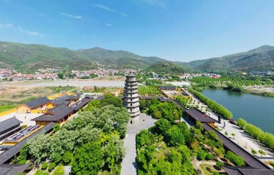 A pagoda surrounded by traditional buildings and a river. 3
