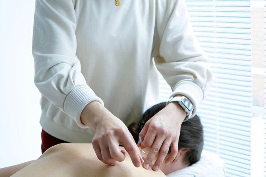 A person receiving a massage on a massage table. 1