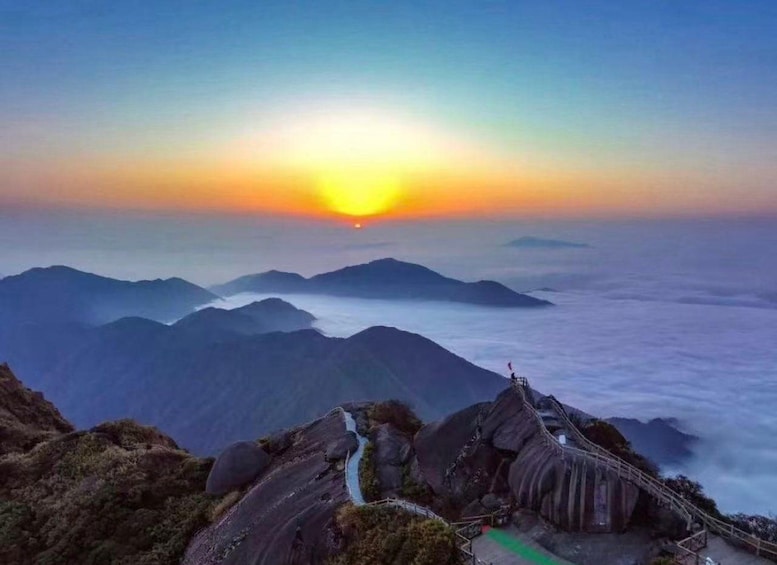 A mountain landscape with a sunset, a winding road, and a bridge. 3