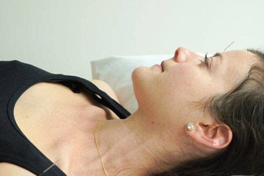 A person lying down with a paper on their chest. 2