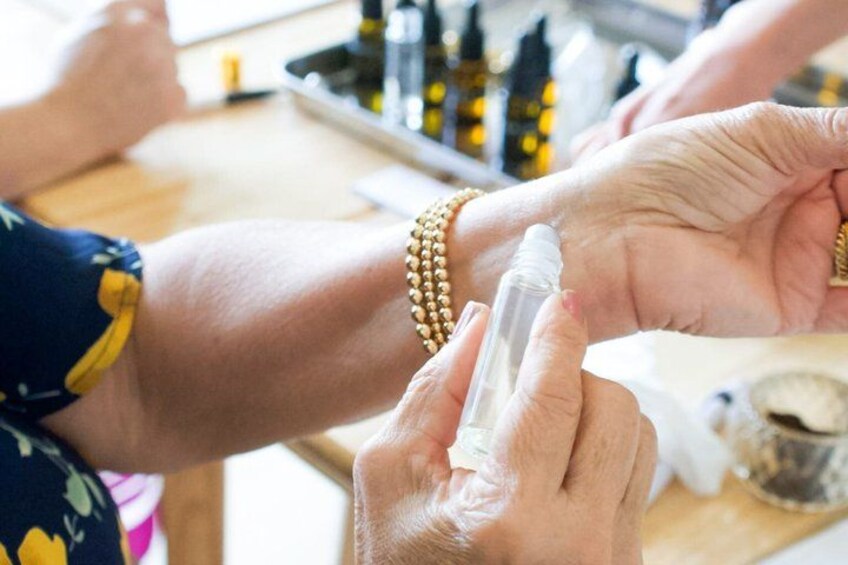 A person applying a cream or lotion to another person's arm. 2