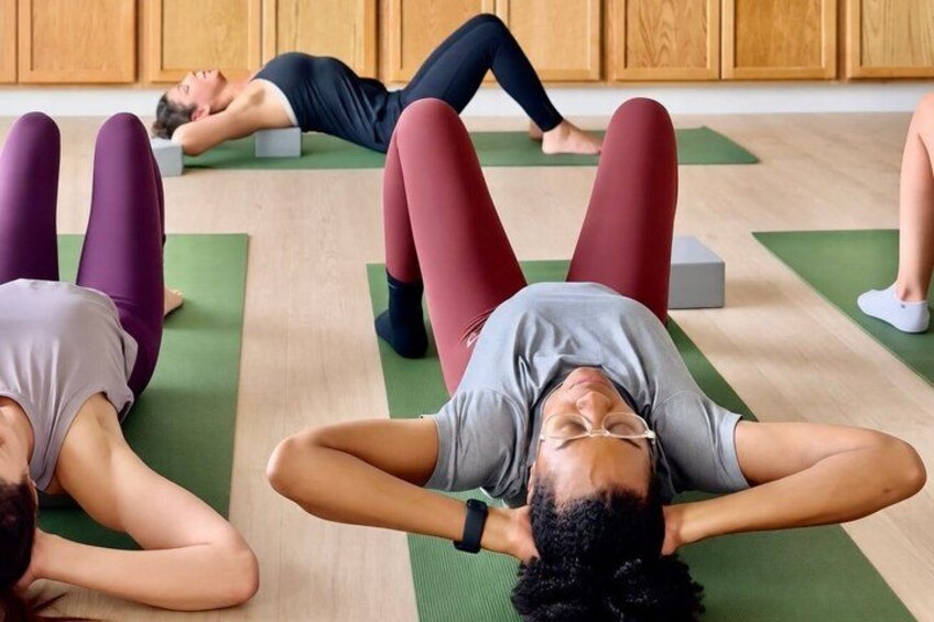 People lying on mats in a room. 1
