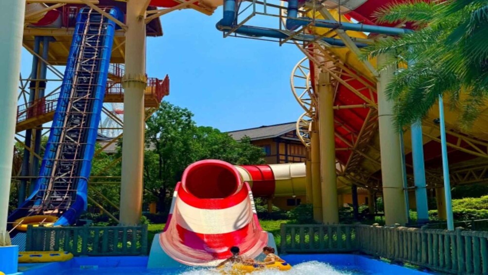 A water slide with a red and white funnel structure, a blue slide, and a water pool at the bottom. 2