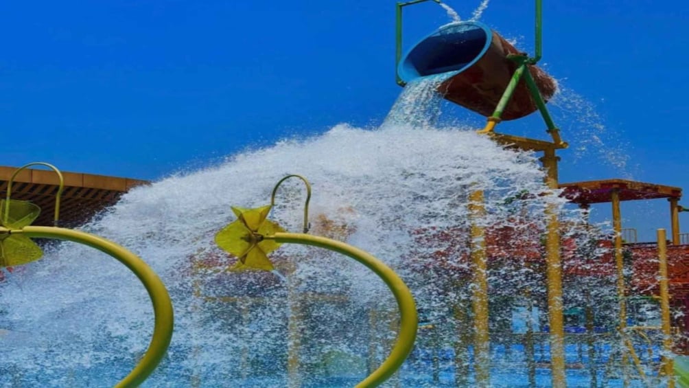 A water fountain with a bucket pouring water, surrounded by yellow rings. 1