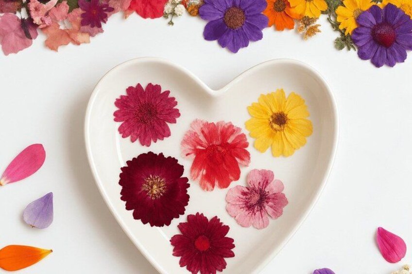 A white heart-shaped plate with dried flowers. 5
