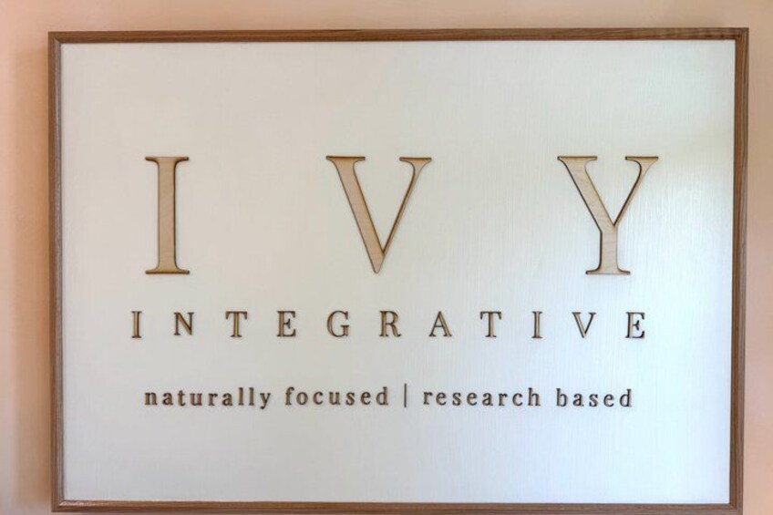 A framed sign with the text 'IVY INTEGRATIVE' and the phrases 'naturally focused | research based' below it. 2