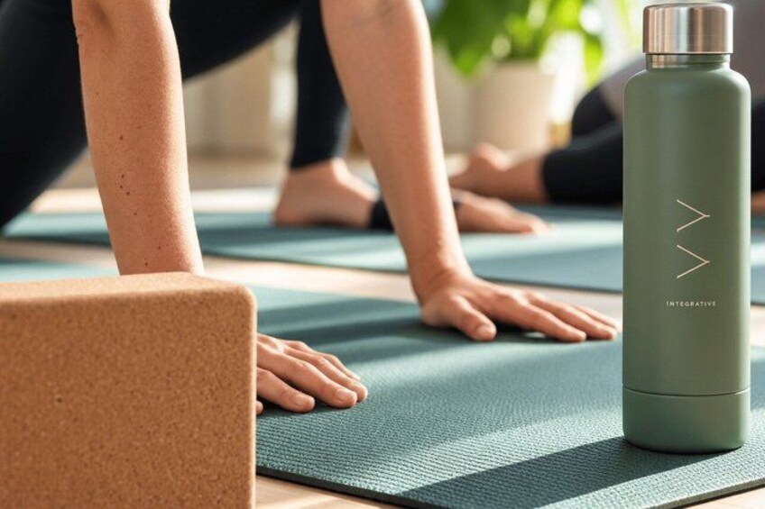 A person practicing yoga on a mat with a water bottle nearby. 2