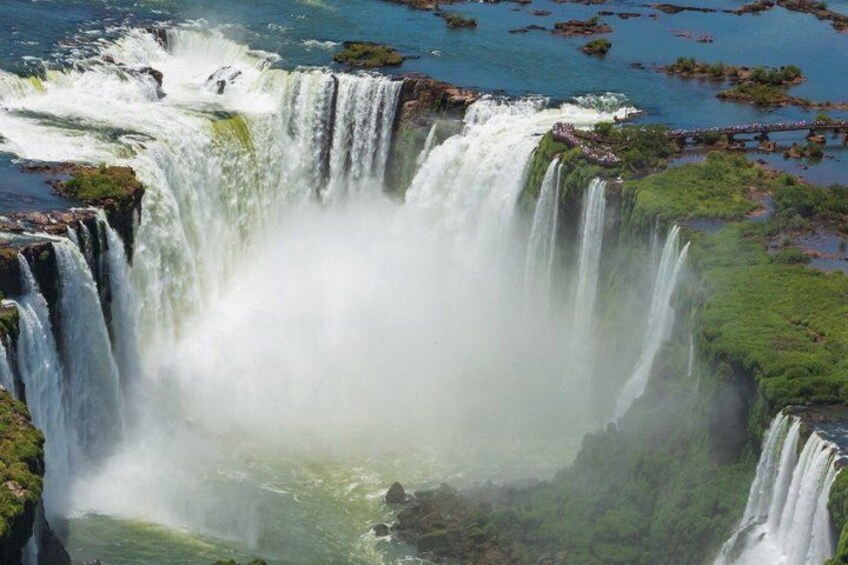 A multi-tiered waterfall with lush greenery around it. 4