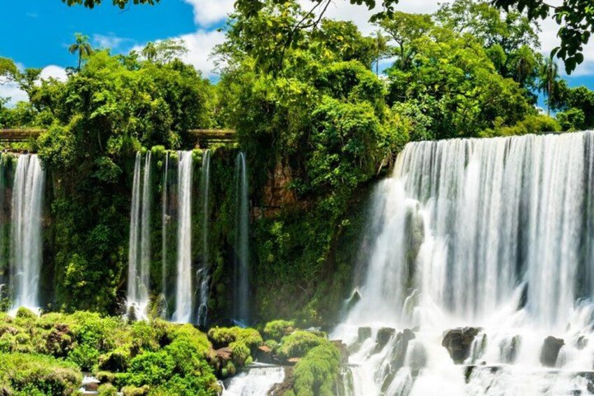 A multi-tiered waterfall surrounded by lush greenery. 2