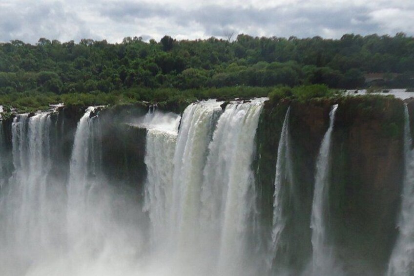 A large waterfall with multiple cascades surrounded by dense greenery. 5