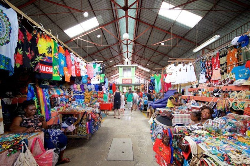 An indoor market with various stalls selling colorful textiles and accessories. 4