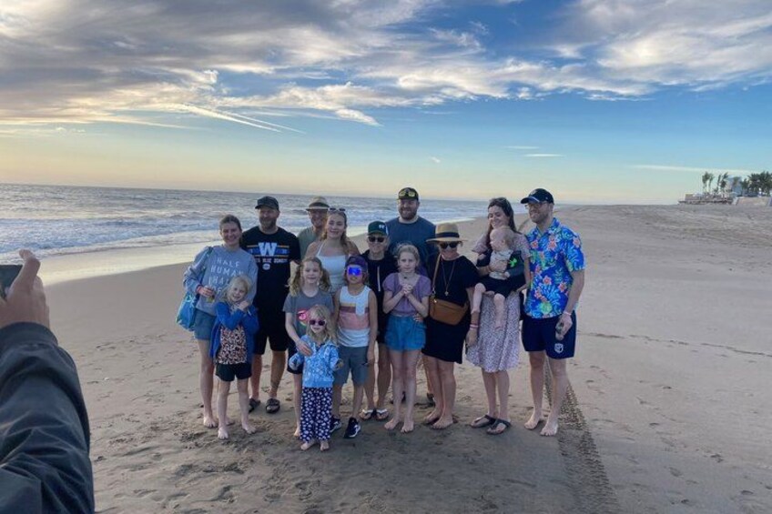 A group of people on a beach with the ocean in the background. 4