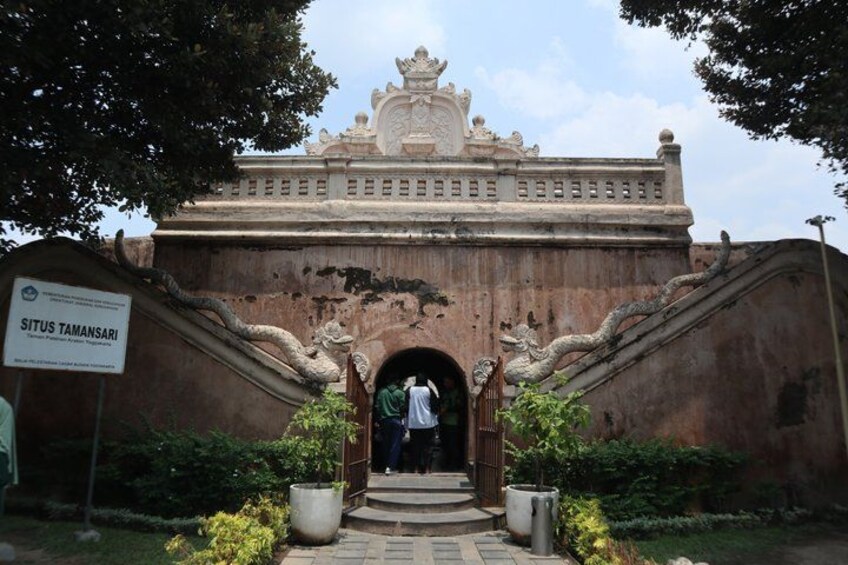 A traditional gate with intricate carvings and a sign reading 'Situs Tamansari.' 2