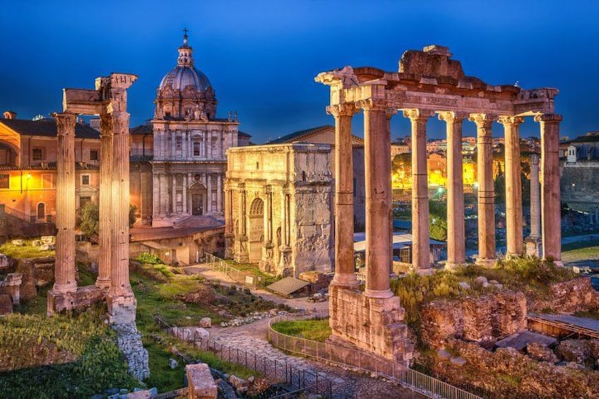 Ancient ruins with columns and a domed building. 1