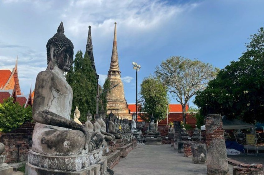 A large Buddha statue, a pagoda, and traditional Thai architecture. 5