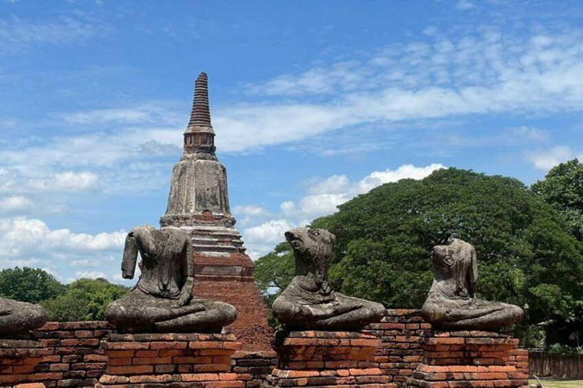 A stupa with a brick base, surrounded by stone lion statues. 3