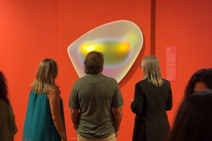 People viewing an abstract art installation in a museum. 1