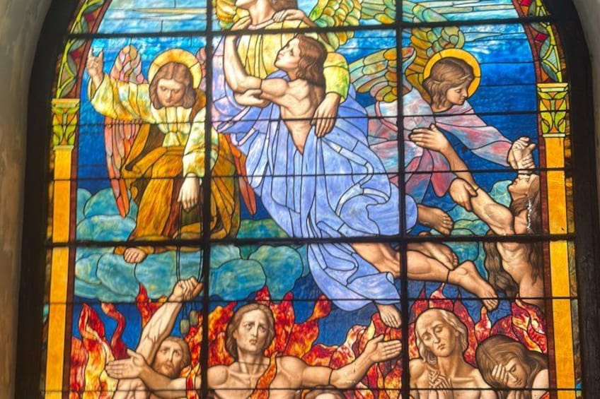 A stained glass window with religious figures and flames. 3