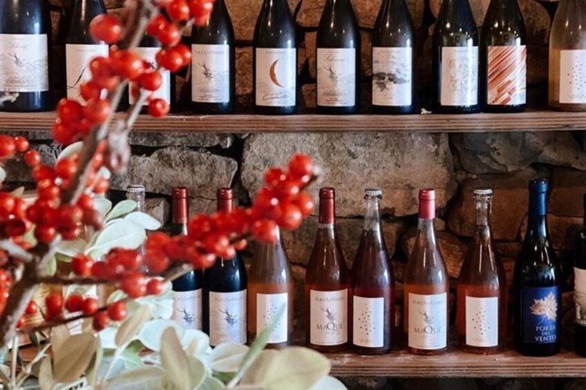 A wine rack with various bottles, some with labels visible. 4
