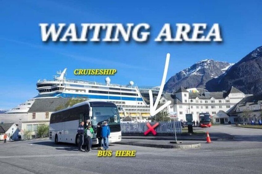 A waiting area with a cruise ship in the background, a bus, and a mountain range. 4