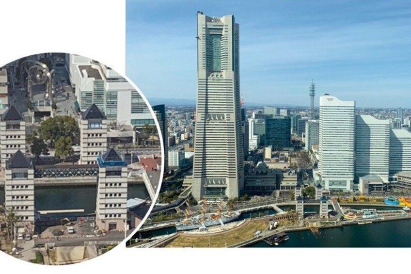 A cityscape with modern skyscrapers, a river, and a bridge. 2