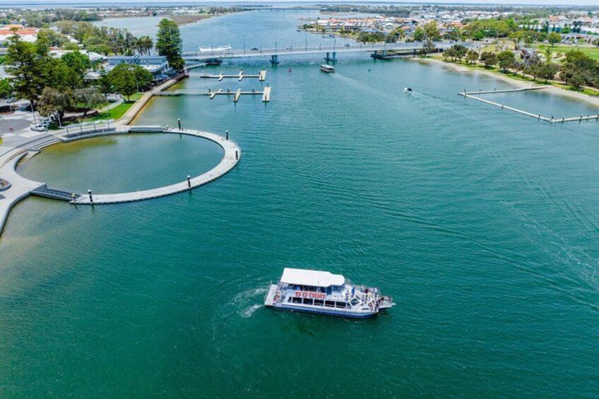 A river with a boat, a bridge, and a circular park area. 3