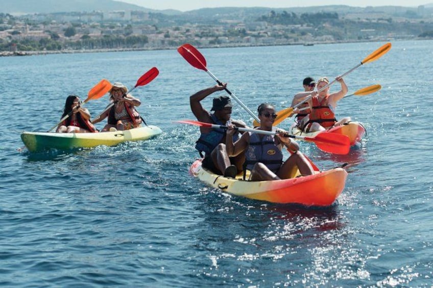 People kayaking on a calm body of water with a distant shoreline. 1