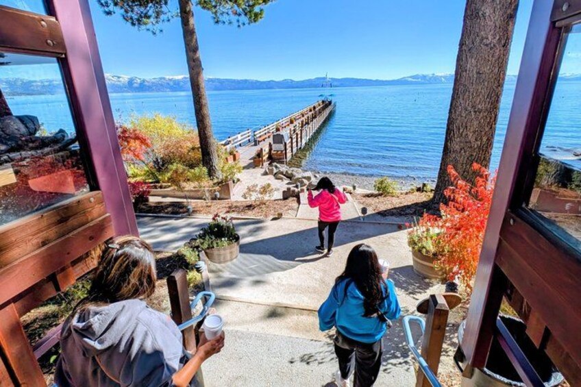 A wooden staircase leading to a lakeside area with a wooden pier extending into the water. 5