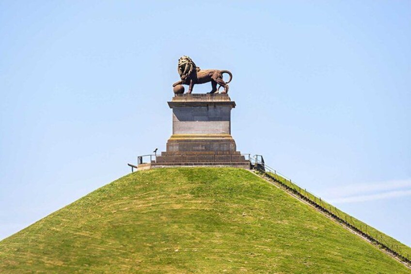 A lion statue on a hilltop monument. 1
